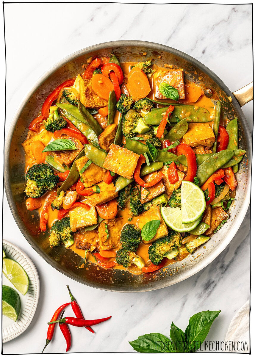 This easy vegan Thai red curry is creamy, cozy and packed with tender veggies and tofu in a rich coconut curry sauce. Perfect for busy days! Skillet of vegan Thai red curry.