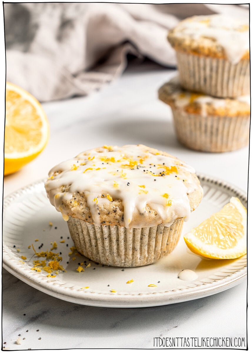 Glazed vegan lemon poppy seed muffin on plate.