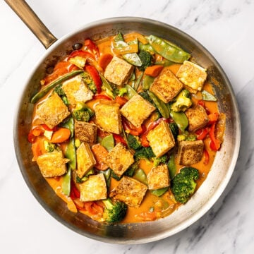 Skillet of vegan Thai red curry with tofu and vegetables.