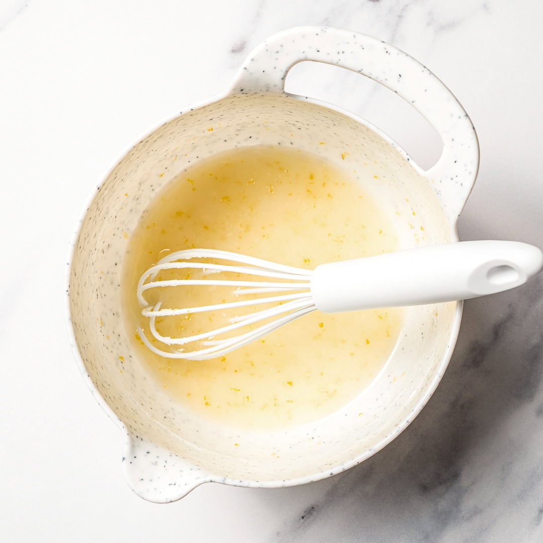 Whisk in bowl with lemon glaze.