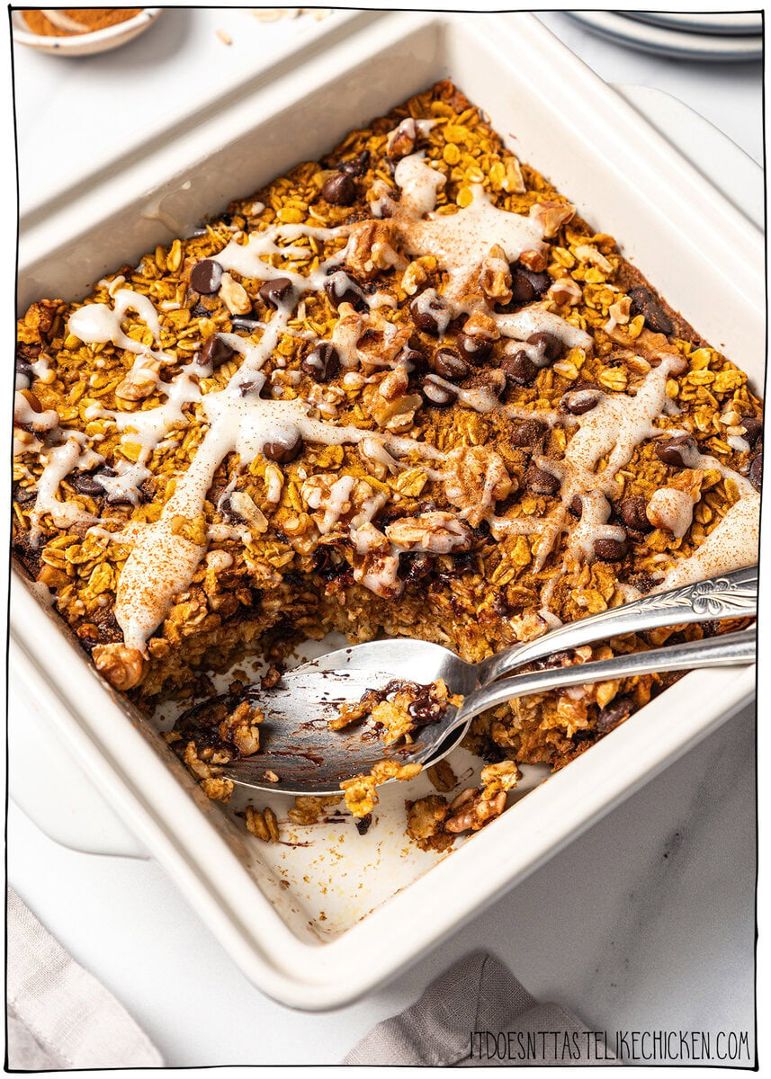 Pumpkin baked oatmeal in dish with two spoons.