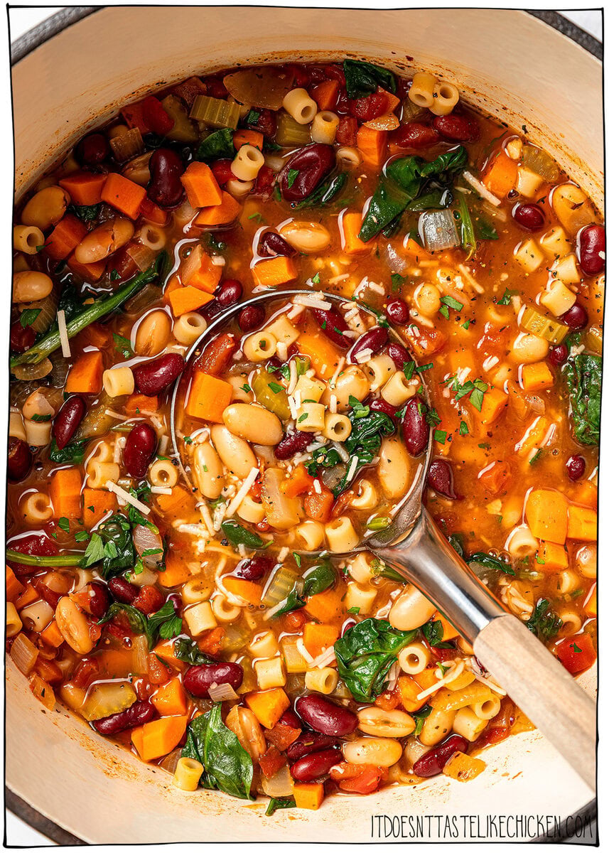 This vegan pasta e fagioli soup is hearty, cozy, and loaded with beans, pasta, and vegetables in a rich tomato broth. A budget-friendly meal! Ladle in pot of vegan pasta e fagioli.