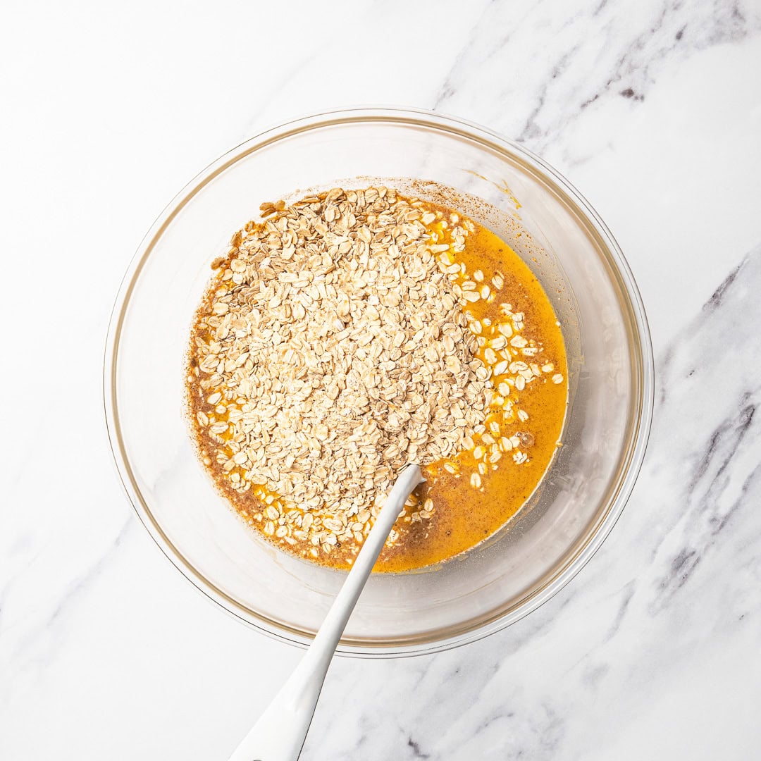 Oats added to bowl of pumpkin mixture.