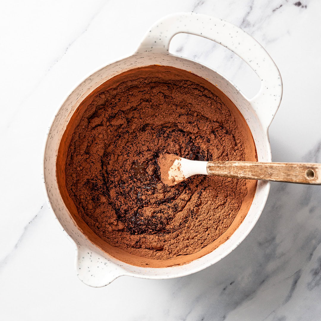 These vegan Sweet Potato Brownies are rich, fudgy, and loaded with deep chocolate flavor. You'd never know they're made with sweet potatoes! Mixing cocoa powder mixture for sweet potato brownies.