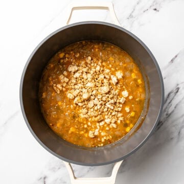Pot of vegan white bean chili with tofu crumbles added.